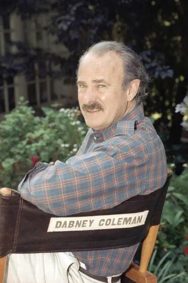 Actor Dabney Coleman sits in a directors chair with his name on it